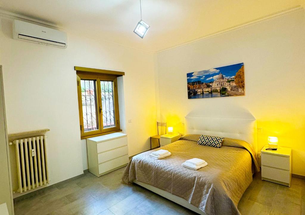 a bedroom with a bed and two tables and a window at Il Giardino Di Maria - Metro C in Rome