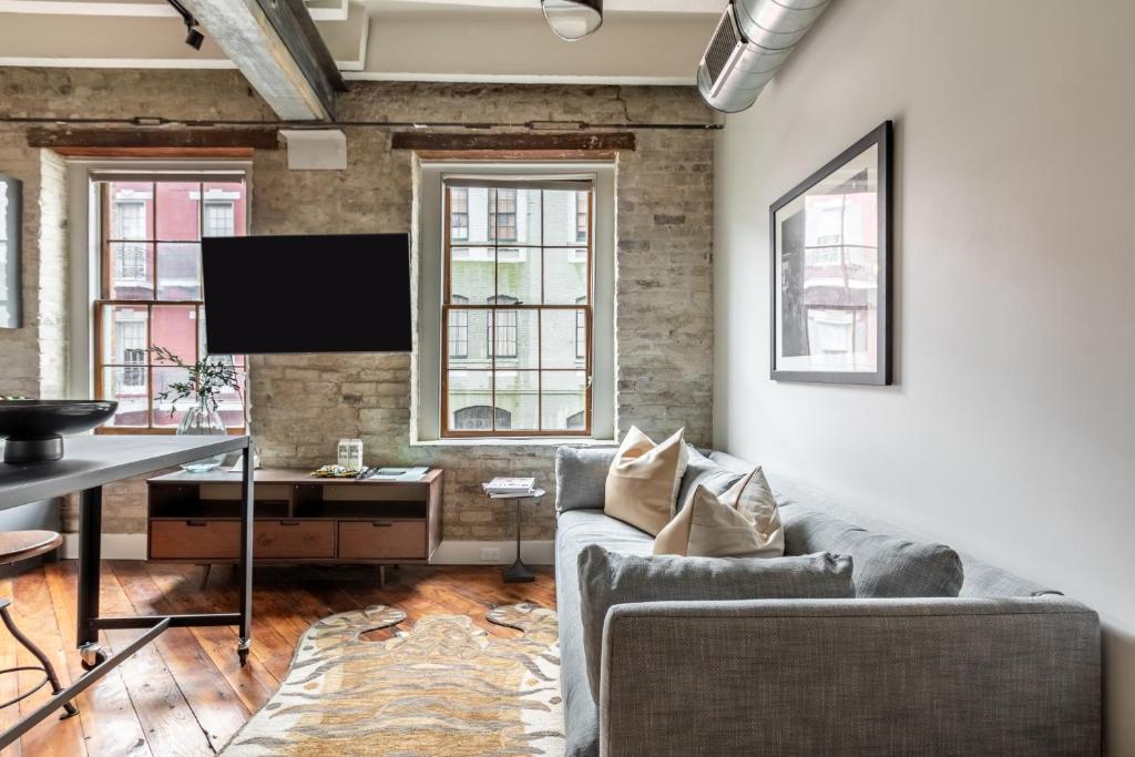 a living room with a couch and a desk at Ironworks Building- 1 Bedroom 1 Bath in New Orleans