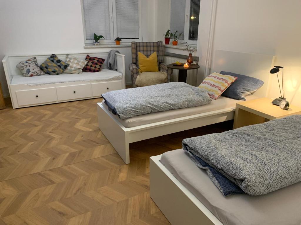 a living room with two beds and a couch at Apartman Slonek in Nové Město na Moravě