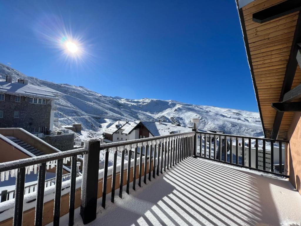 a balcony with a view of the snow covered mountains at Penthouse Luxury Boabdil in Monachil