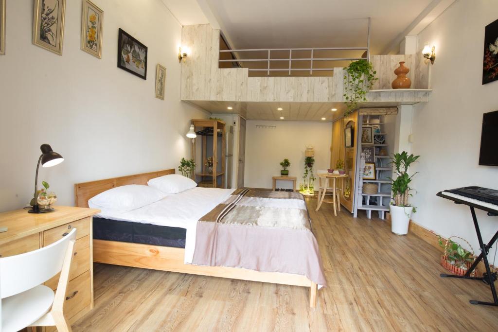 a bedroom with a bed and a desk and a keyboard at Kim Lien's Homestay in Ho Chi Minh City