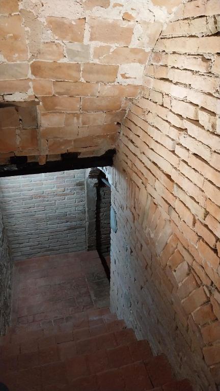 a brick hallway with a brick wall at Borgodieci in Bibbiano