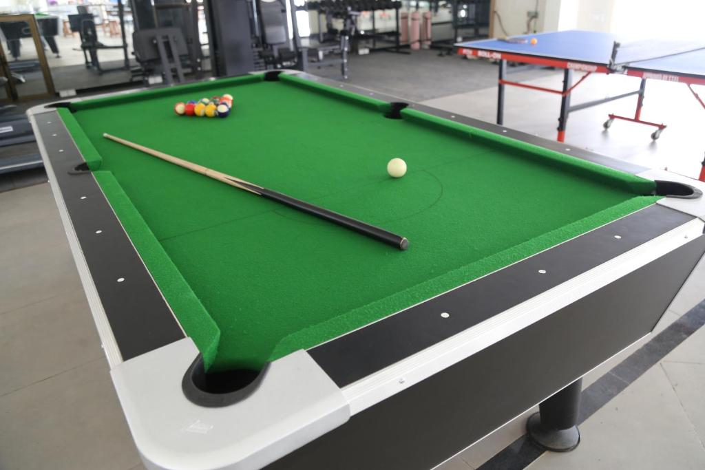 a pool table with two cue sticks and a ball at Suryaansh in Pālghar