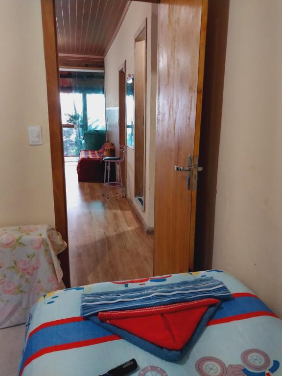 a bedroom with a bed and a door to a living room at Casa verde da água boa Paraty in Paraty