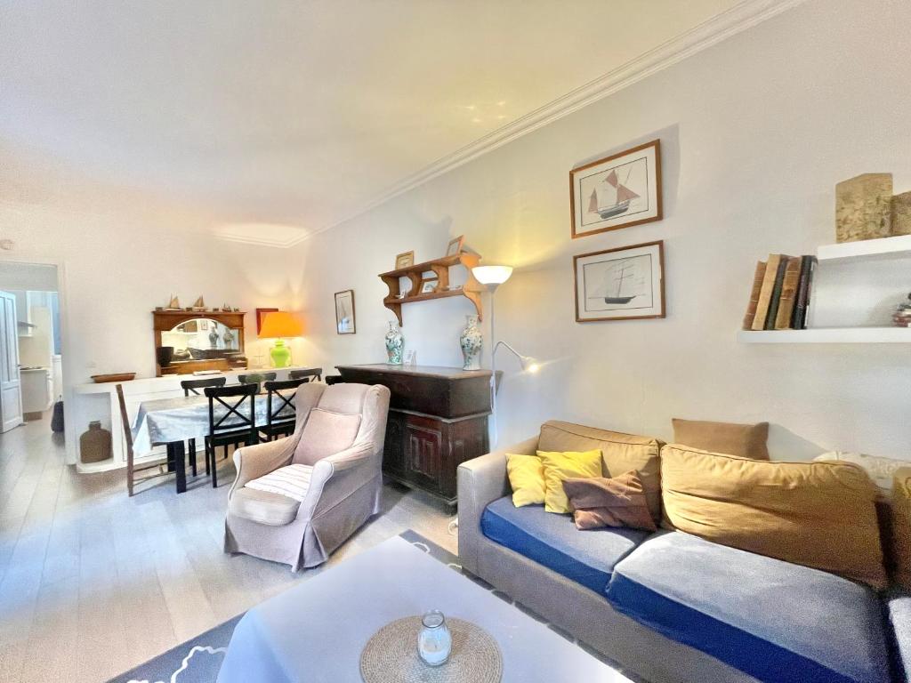 a living room with a couch and a dining room at La Marjolette by Welcome to Cannes in Cannes