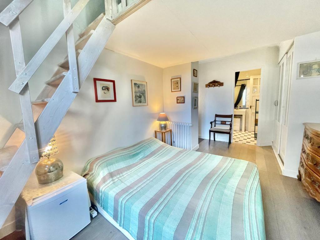 a bedroom with a bed and a staircase at La Marjolette by Welcome to Cannes in Cannes