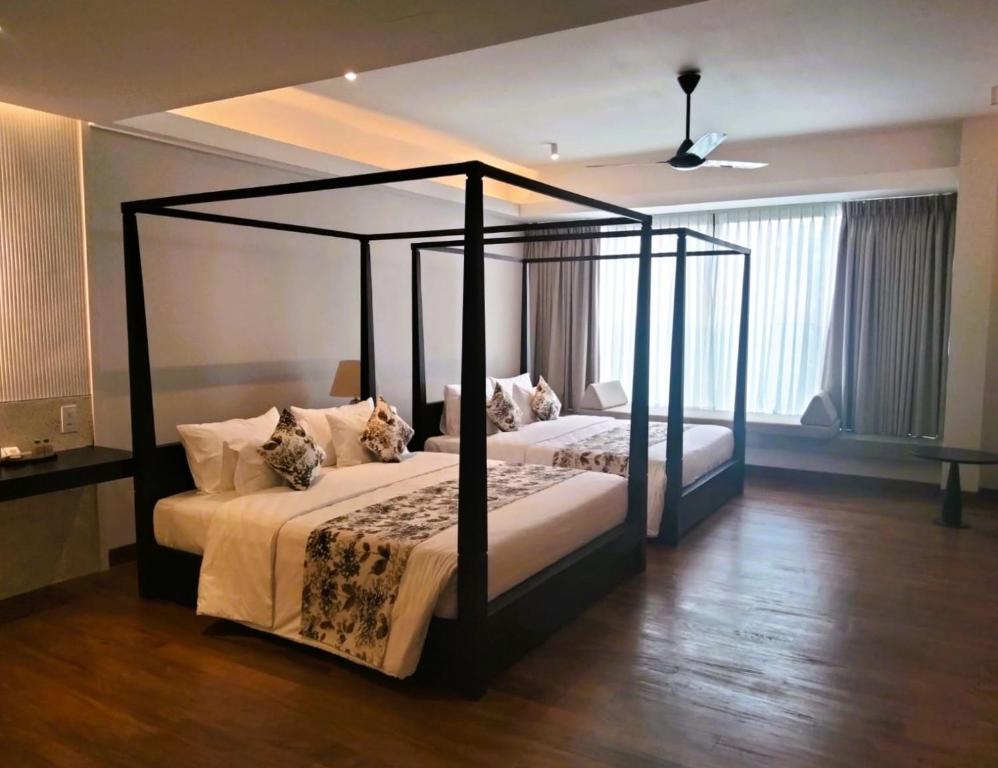Postel nebo postele na pokoji v ubytování Taprobane House