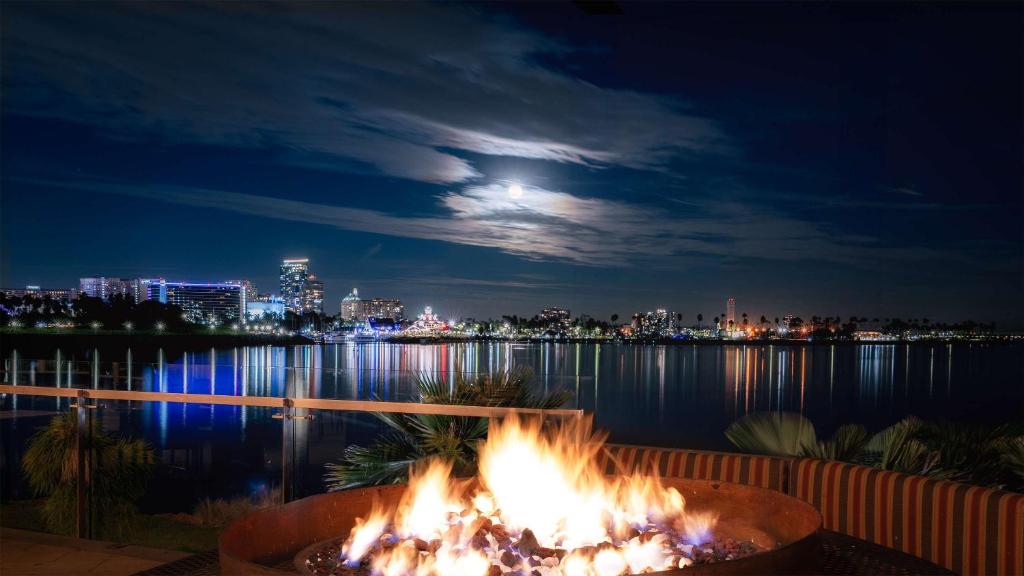 a fire pit in front of the water at night at Hotel Maya - a DoubleTree by Hilton Hotel in Long Beach