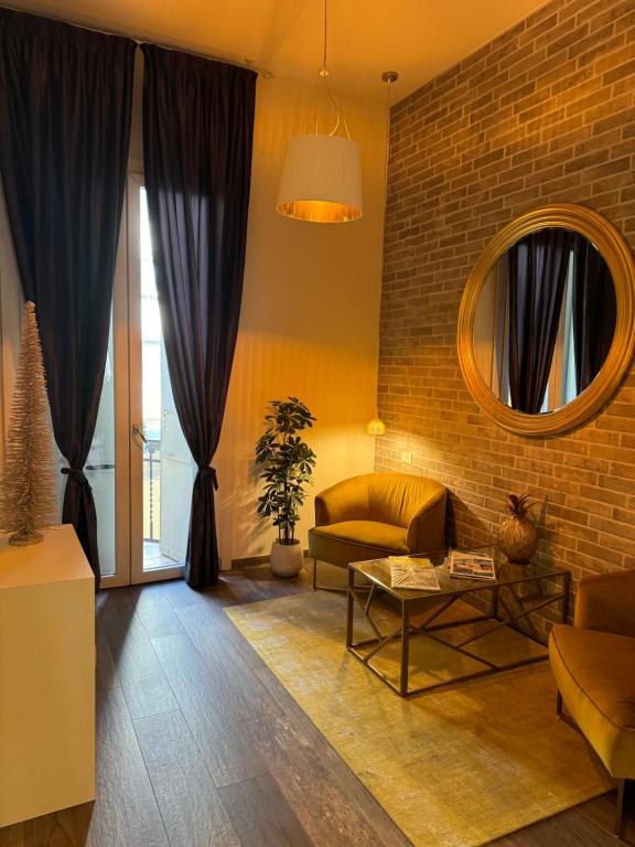 a living room with a couch and a brick wall at Maglo Station in Bologna