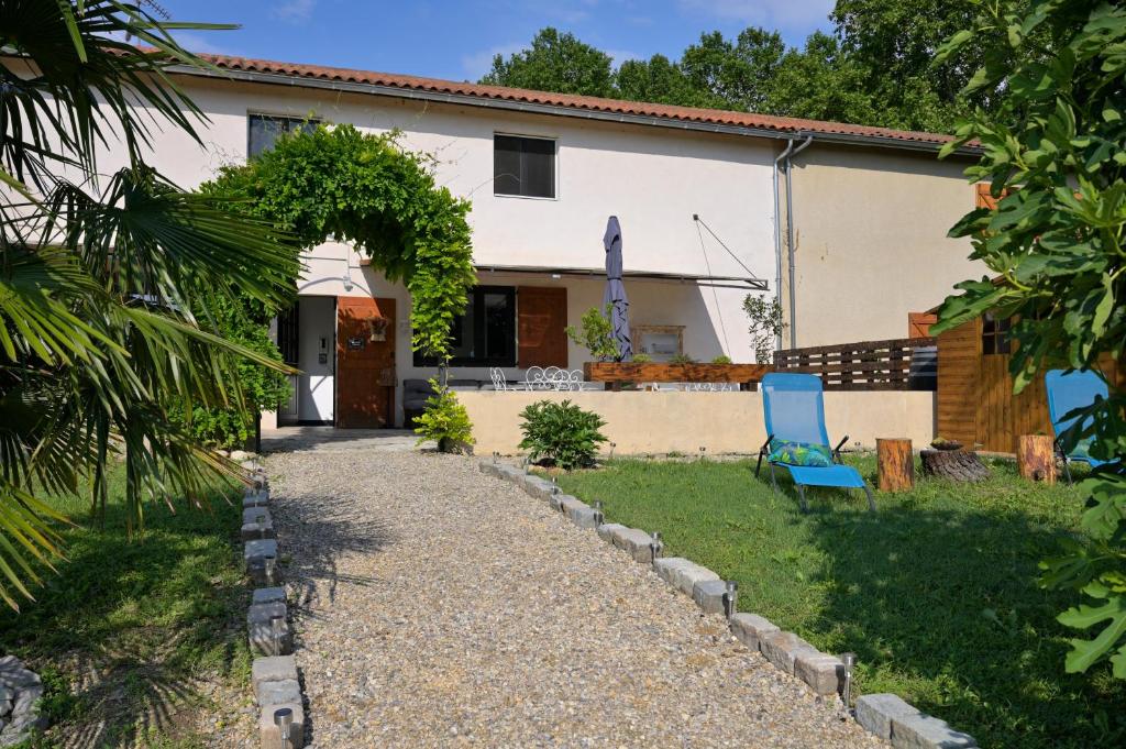 a house with a gravel path in front of it at La bâtisse des Oves in Le Péage-de-Roussillon