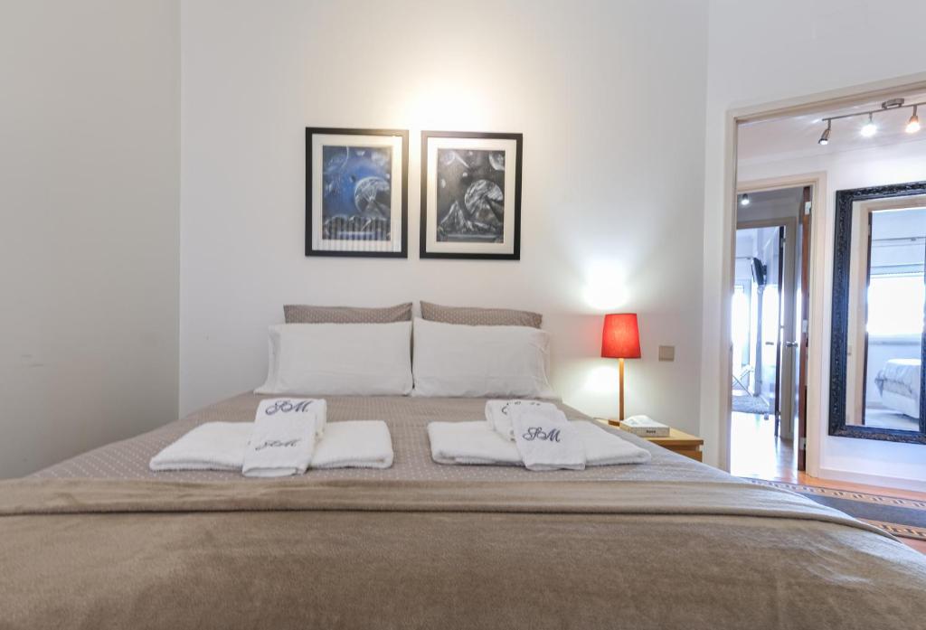 a bedroom with a large bed with two white pillows at Apartment Sol Mar in Ponta Delgada