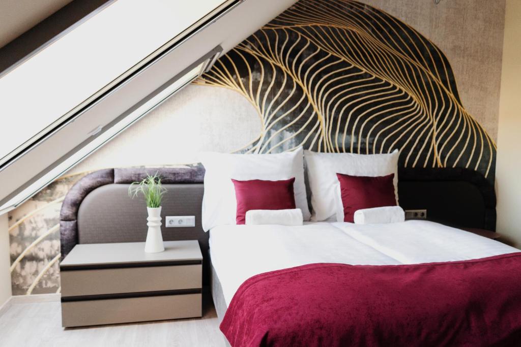a bedroom with a large bed with a large wall at RIVA Boutique Hotel in Szeged