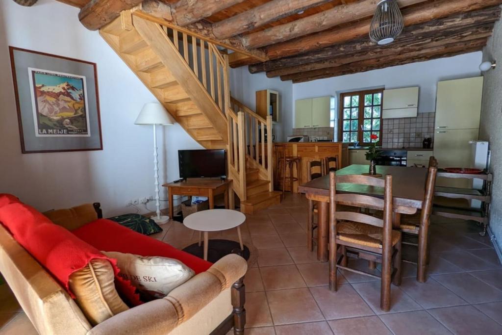 a living room with a couch and a table at Gîte Neige Cordier - Villar d'Arène center 2 bedrooms and large terrace in Villar-dʼArène