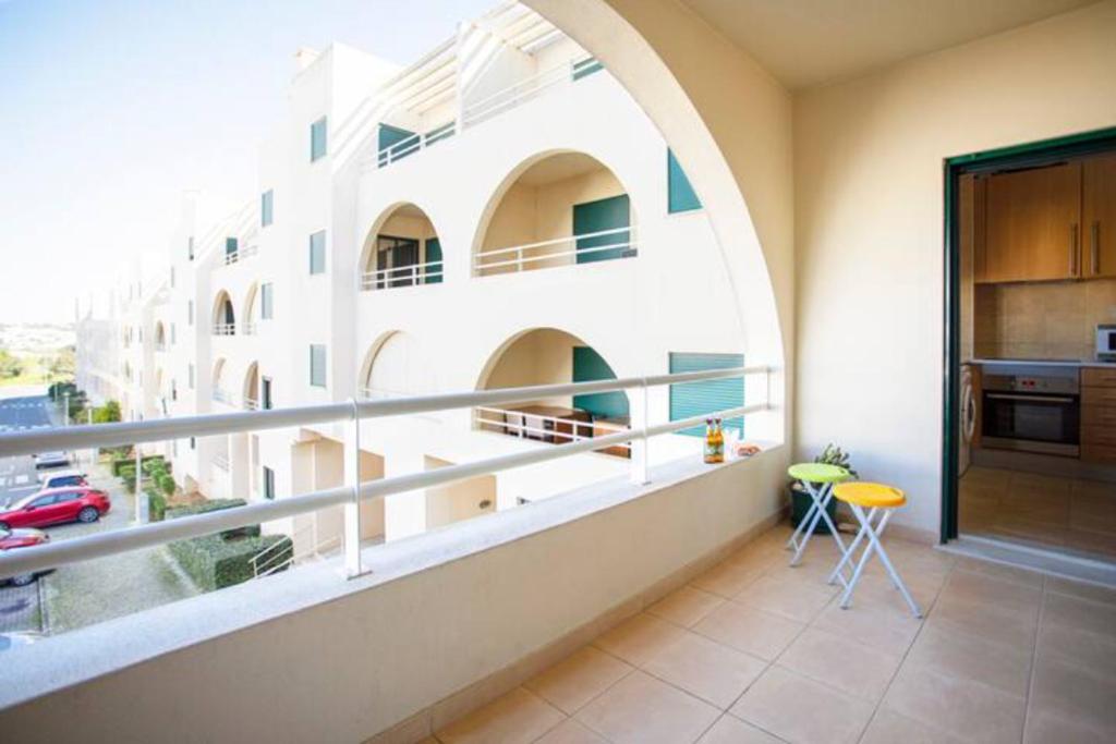 a balcony with an arched window in a building at The Albufeira Concierge - Modern Salgados in Albufeira
