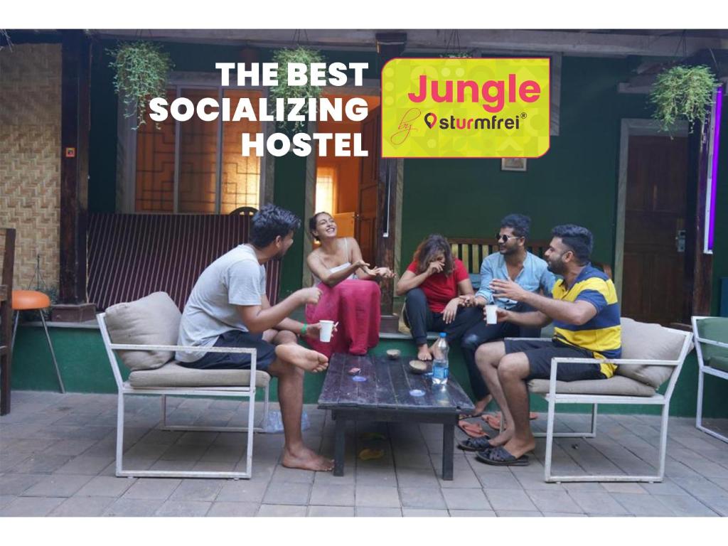 a group of people sitting around a table in chairs at Jungle by sturmfrei Vagator in Vagator