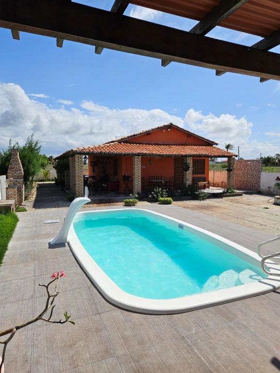 a swimming pool in front of a house at Casa ampla e agradável no Barramares, Luis Correia in Luis Correia