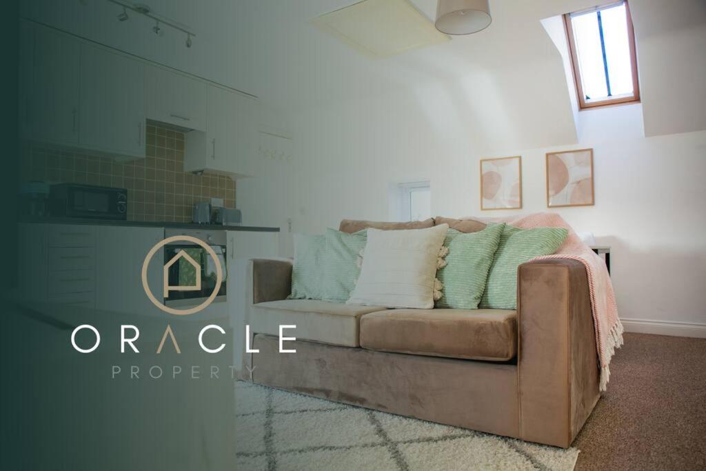 a living room with a couch in a room at Laburnum Maisonettes by Oracle in Stratford-upon-Avon