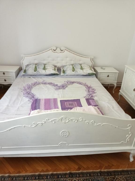 un letto bianco in una stanza con due comodini di Vila Bozica a Jadranovo