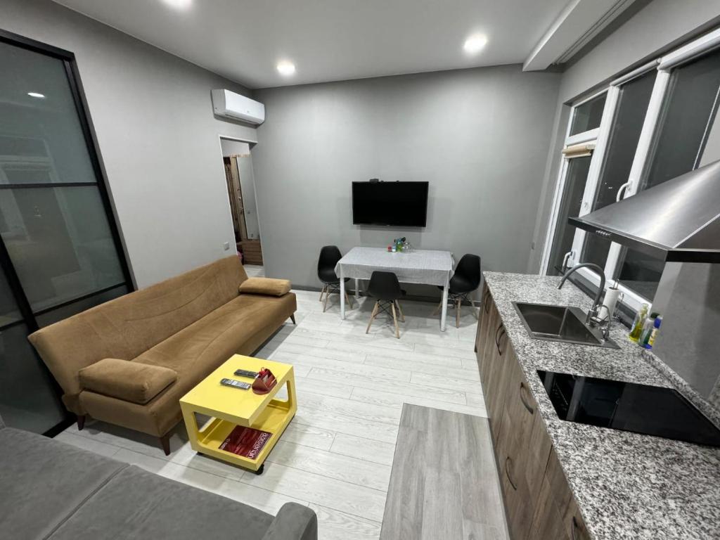 a living room with a couch and a table at RS apartment in Batumi