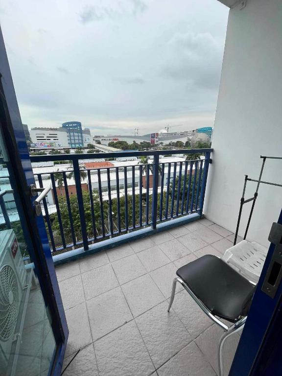 a balcony with a chair and a view of the water at Casa de Sea residence in Manila