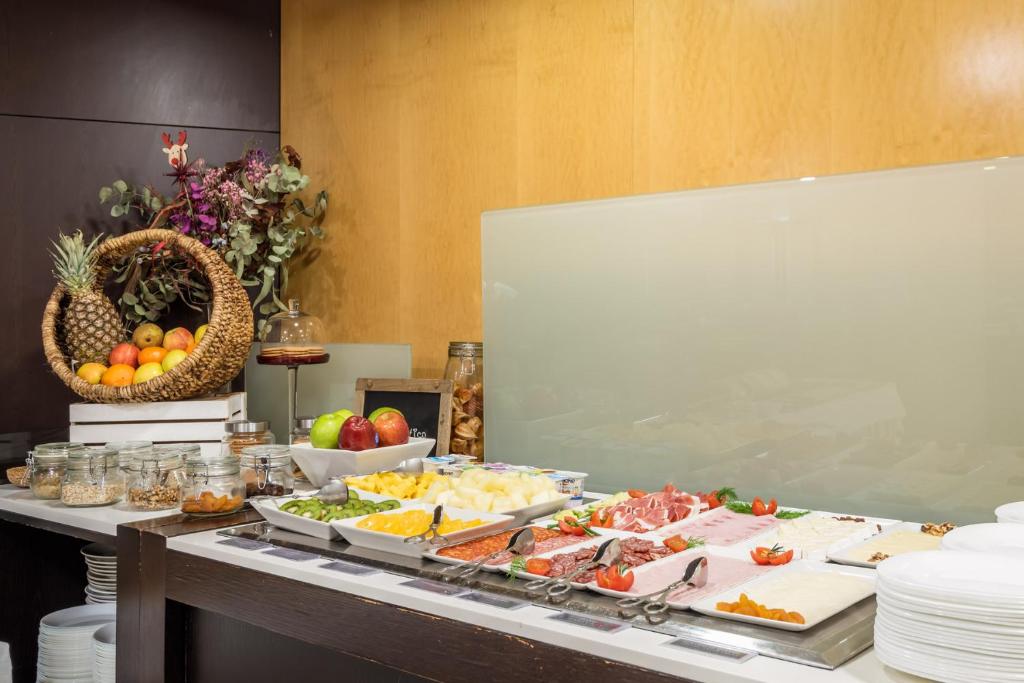 a buffet with many different types of food on a table at Hotel Madanis in Barcelona