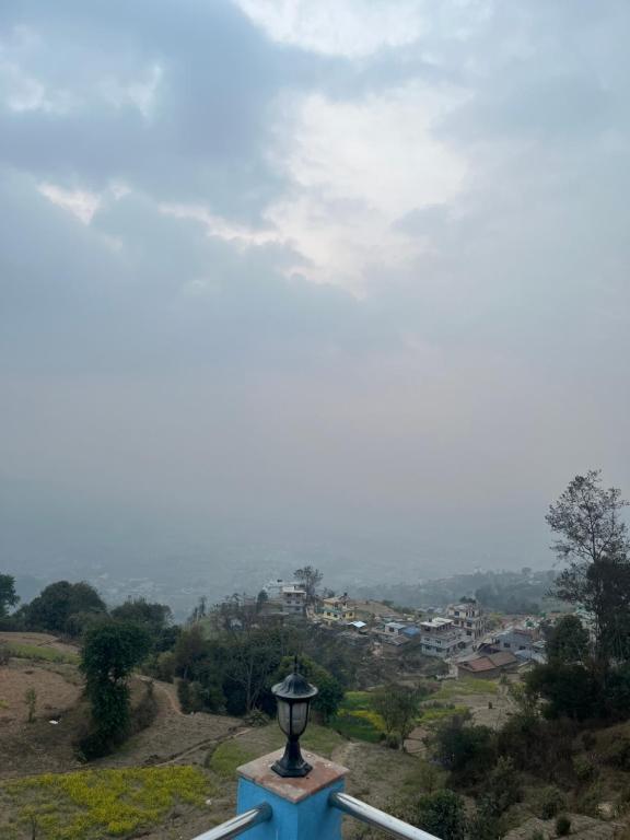 a street light on top of a hill with a city at Nagarkot Valley View Point Resort in Bhaktapur