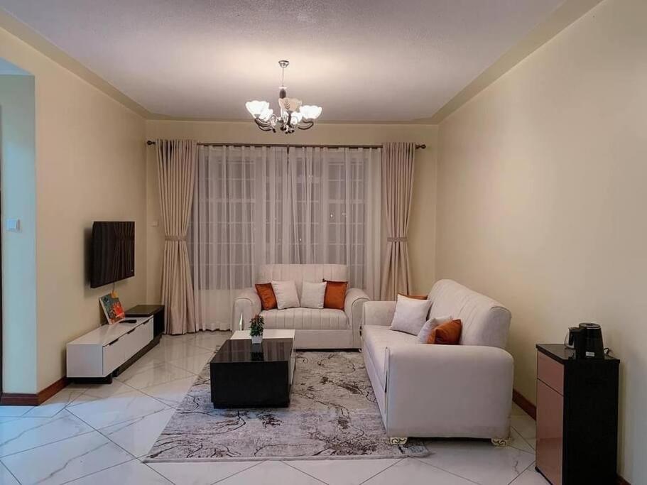 sala de estar con sofá y mesa en Spire Plaza 2 bedroom apartment en Nairobi