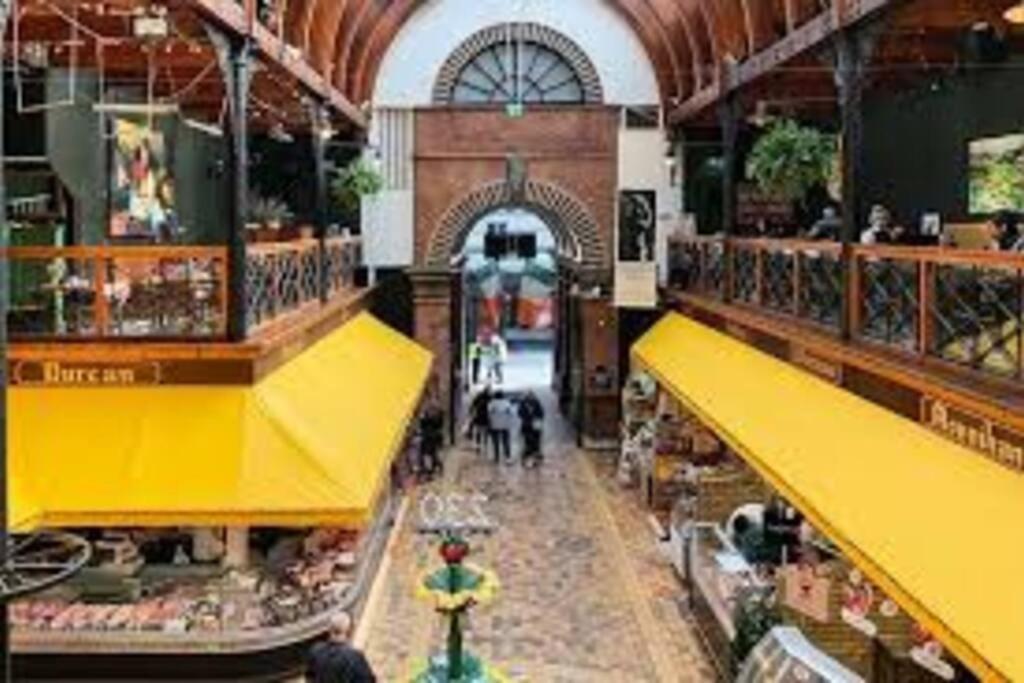 a view of a grocery store with yellow awnings at Cosy City Apartment in Cork