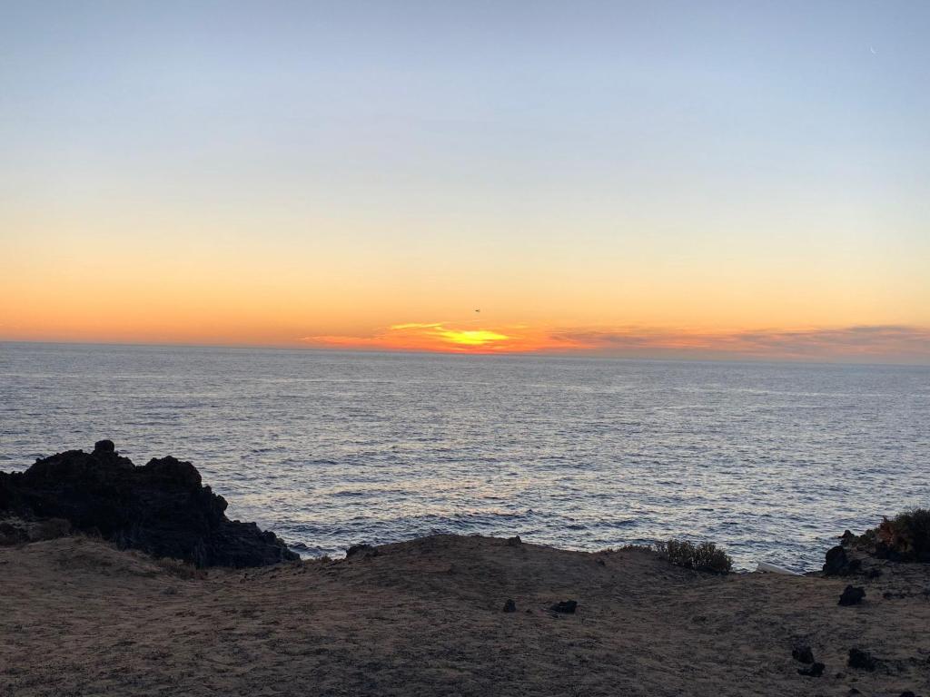 a sunset over the ocean with the sun setting at Love story in Mala