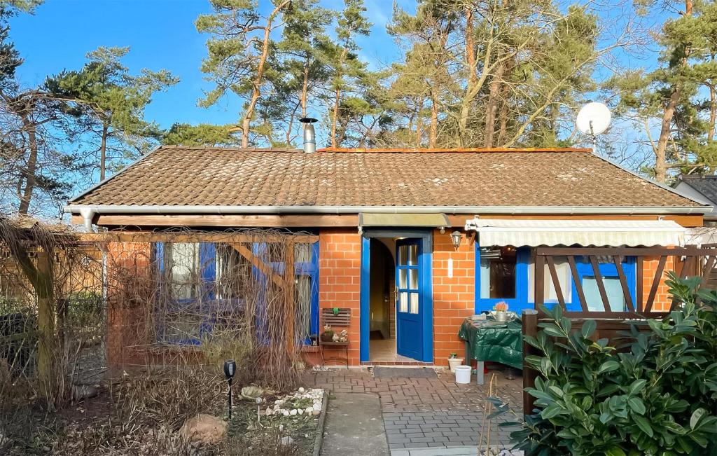 a small red brick house with a blue door at Nice Home In Biendorf With Wi-fi in Biendorf