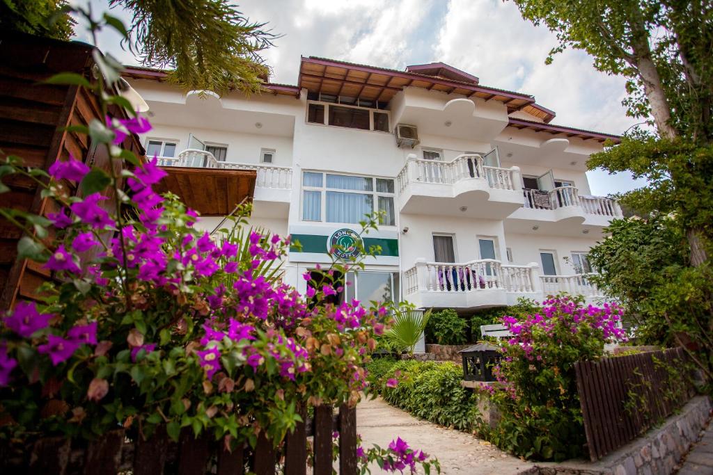 a building with flowers in front of it at London Hotel in Oludeniz