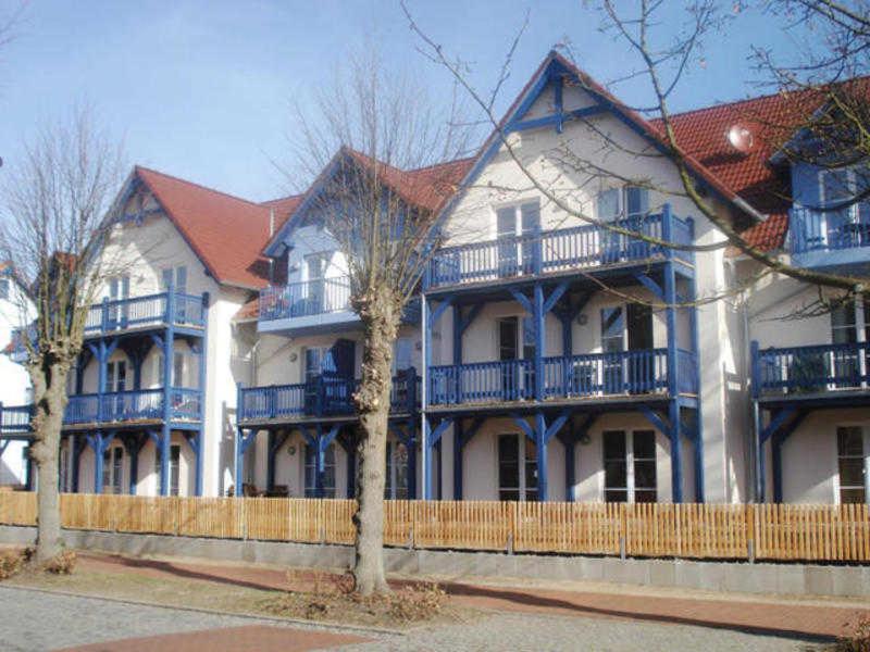 a large blue and white house with blue balconies at Villa Quisisana in der Kurstraße EG in Graal
