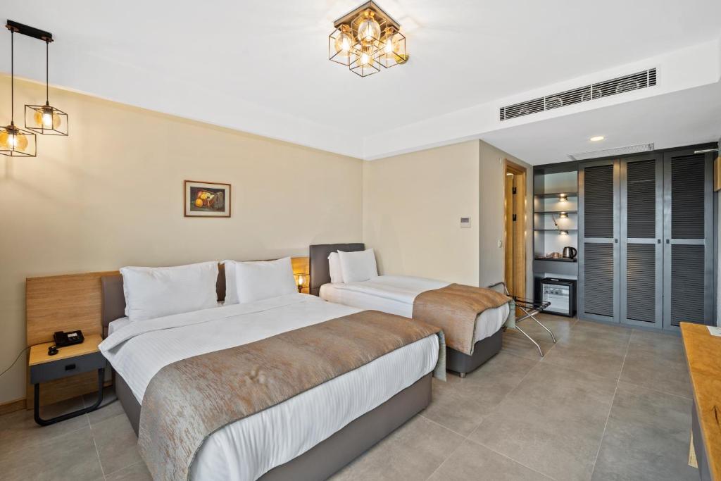 Postel nebo postele na pokoji v ubytování ZEYT INN HOTEL