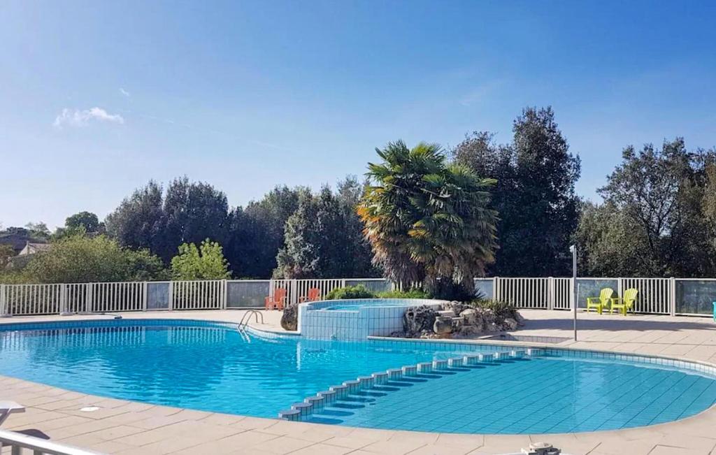 a large blue swimming pool in a yard at Lovely Home In Saint-savinien With Outdoor Swimming Pool in Saint-Savinien