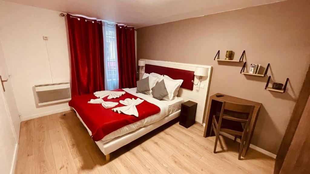 una camera da letto con un letto con una coperta rossa e una finestra di Jeff Hotel a Parigi