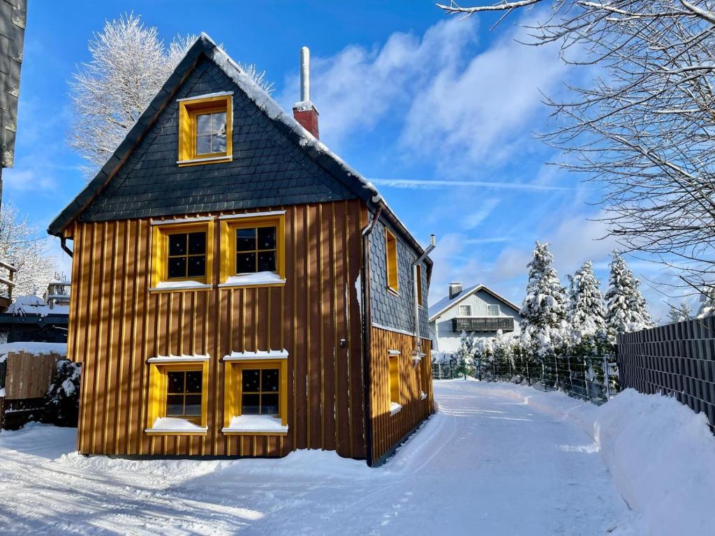 a wooden house in the snow at Hexenhaus in Clausthal-Zellerfeld