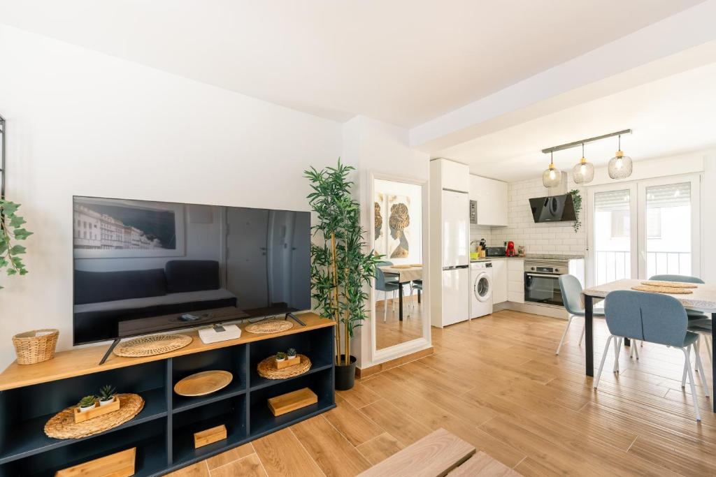 a living room with a table and a dining room at APARTAMENTO EN LA PLAYA DE BENIDORM in Benidorm
