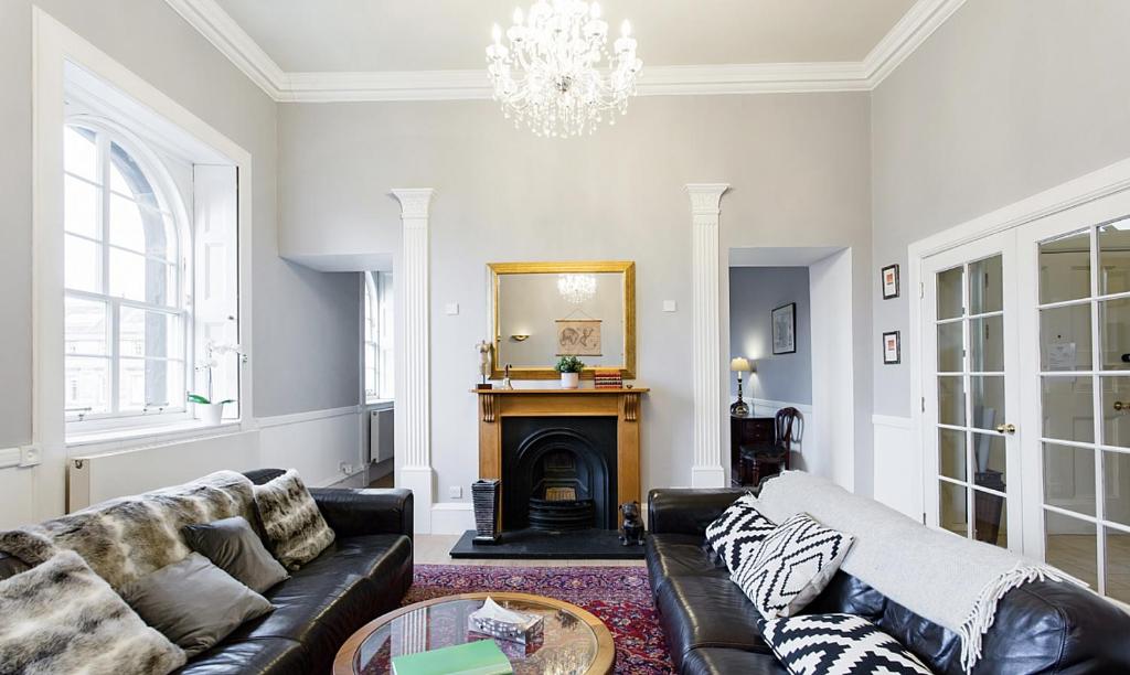 a living room with a couch and a fireplace at Royal Mile Apartments in Edinburgh