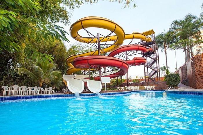 a water slide in the middle of a swimming pool at Golden Dolphin Grand Hotel in Caldas Novas