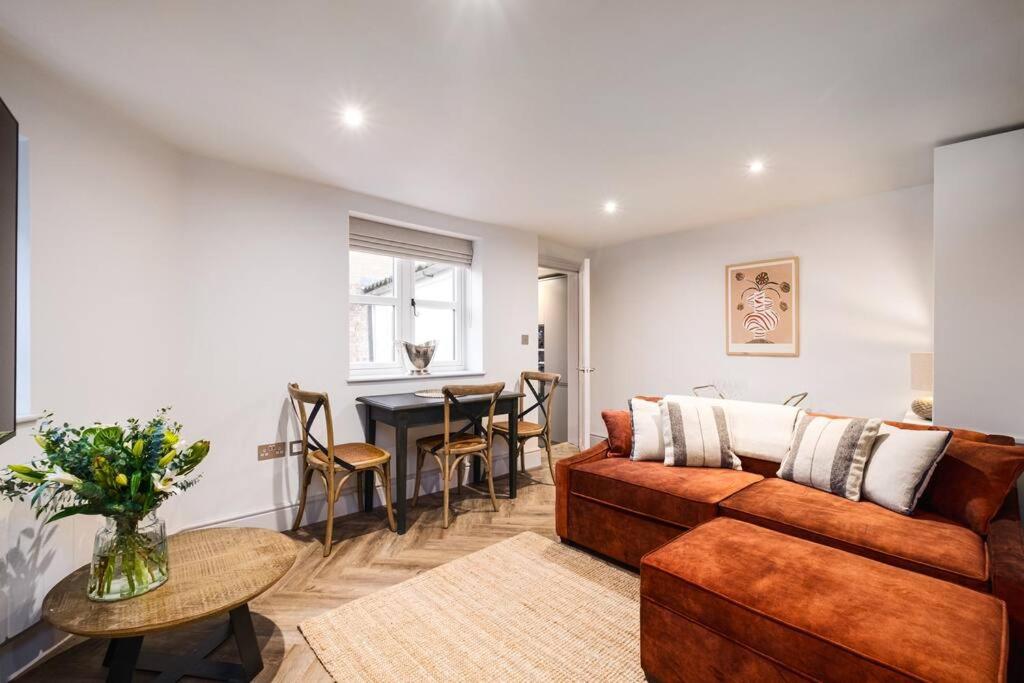 a living room with a couch and a table at Great Escapes Oundle Flat 2 in Oundle