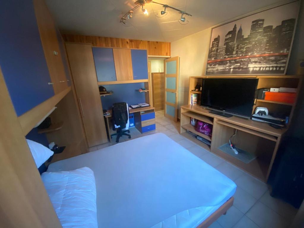 Ένα ή περισσότερα κρεβάτια σε δωμάτιο στο Appart a 10 min de 3 stations de ski