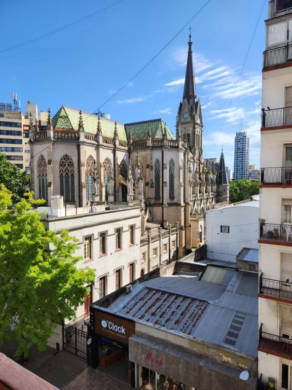 un antiguo edificio con una torre de reloj en una ciudad en Hermoso ambiente frente a la Catedral excelente wifi en Mar del Plata