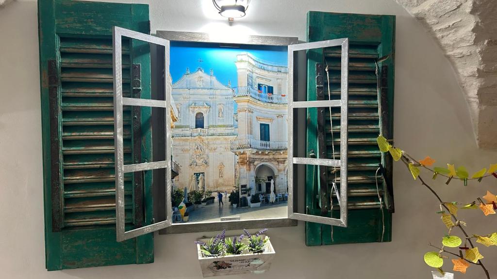 a picture of a church seen through a window at La dimora di zio Nino in Martina Franca