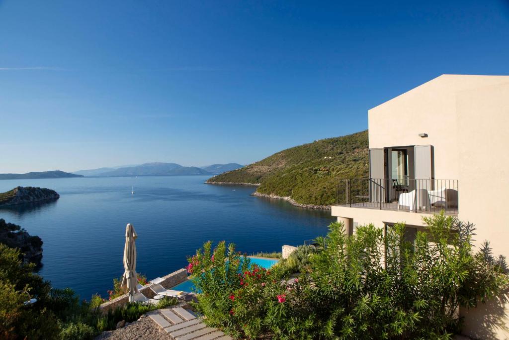 una casa con vistas a un cuerpo de agua en Villa Kastos - Stylish Luxury Villa with Direct Sea Access, en Sivota