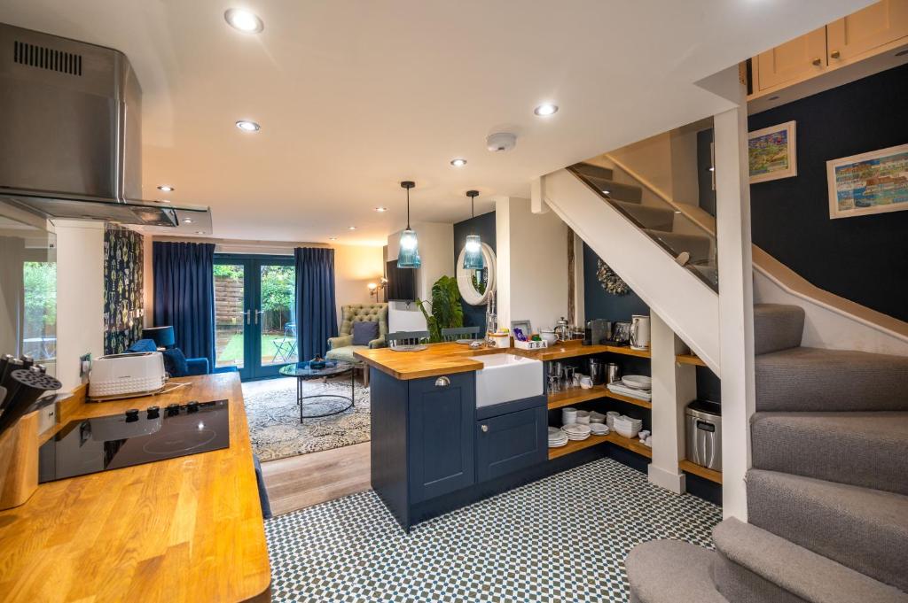 a kitchen with a staircase and a living room at No 33 Cottage 2 in Thornham