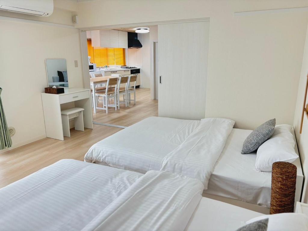 Ένα ή περισσότερα κρεβάτια σε δωμάτιο στο Neighbor's Hotel 十日市