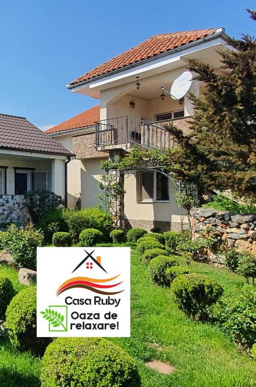 a house with a sign in front of a yard at Casa Ruby in Mangalia