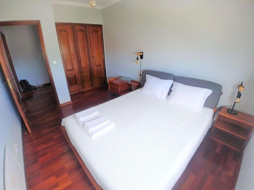 a bedroom with a large bed with white sheets at Be Local - Apartment with 3 bedroom near Oriente Station in Lisbon in Lisbon