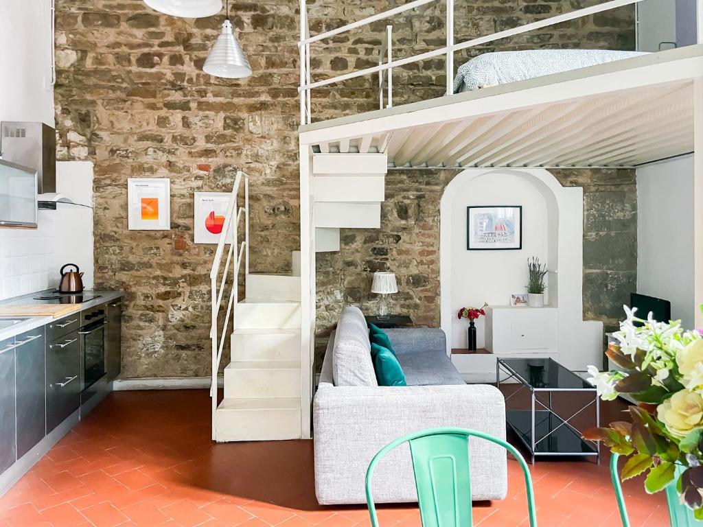 a living room with a couch and a loft bed at Lovely Apartment near Piazza della Signoria in Florence