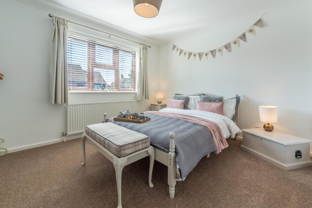 a bedroom with a bed and a window at One Lazy Duck in Heacham